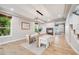 Bright dining room featuring hardwood floors, a modern chandelier, and a view of the fireplace at 46093 Bristlecone Ct, Parker, CO 80138