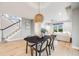 Bright dining room with modern light fixture, wood floors, and easy access to living room at 46093 Bristlecone Ct, Parker, CO 80138