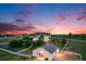 Beautiful home with a large barn on a fenced lot, set against a colorful sunset sky at 46093 Bristlecone Ct, Parker, CO 80138