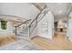 Bright foyer with hardwood floors, elegant staircase, and arched doorway at 46093 Bristlecone Ct, Parker, CO 80138