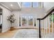 Bright foyer featuring a soaring ceiling, elegant staircase, and decorative glass double doors at 46093 Bristlecone Ct, Parker, CO 80138