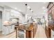 Spacious kitchen with stainless steel appliances, island with sink, and white cabinets at 46093 Bristlecone Ct, Parker, CO 80138