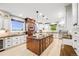 Large kitchen with custom cabinets, granite countertops, stainless appliances, and a spacious center island at 46093 Bristlecone Ct, Parker, CO 80138