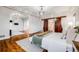 Spacious main bedroom boasts wood floors, chandelier, and sliding barn door to bathroom and closet at 46093 Bristlecone Ct, Parker, CO 80138