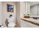 Clean and updated half bathroom with a pedestal sink and tiled flooring at 7725 S Cove Cir, Centennial, CO 80122