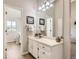 Clean bathroom with a vanity, mirror, and tiled flooring at 7725 S Cove Cir, Centennial, CO 80122