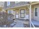 Brick townhouse with a front porch and two chairs at 7725 S Cove Cir, Centennial, CO 80122