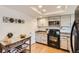 Updated kitchen with stainless steel countertops and white shaker cabinets at 7725 S Cove Cir, Centennial, CO 80122