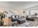 Bright living room with hardwood floors, comfy seating, and a staircase at 7725 S Cove Cir, Centennial, CO 80122