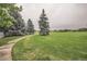 Green park with walking path and lush trees at 7725 S Cove Cir, Centennial, CO 80122