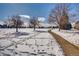 Snow-covered park with walking path and trees at 7725 S Cove Cir, Centennial, CO 80122