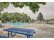 Community pool with lounge chairs and picnic tables at 7725 S Cove Cir, Centennial, CO 80122