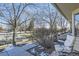 View from the side yard showing trees and a bench at 7725 S Cove Cir, Centennial, CO 80122