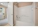Bathroom featuring a shower-tub combo with white tile and a convenient towel rack at 11640 W 62Nd Pl # 203, Arvada, CO 80004