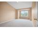 Bright and spacious bedroom with neutral carpet and large window with neighborhood views at 11640 W 62Nd Pl # 203, Arvada, CO 80004