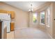 Bright dining area featuring a bay window nook and carpeted floors at 11640 W 62Nd Pl # 203, Arvada, CO 80004