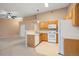 Well-lit kitchen with wood cabinets and standard appliances, open to the living area at 11640 W 62Nd Pl # 203, Arvada, CO 80004