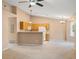 Cozy kitchen featuring wood cabinets and bright white appliances, open to the living space at 11640 W 62Nd Pl # 203, Arvada, CO 80004