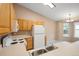 Efficient kitchen space with bright cabinets and a view into the dining room at 11640 W 62Nd Pl # 203, Arvada, CO 80004