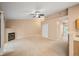 Open living room with neutral carpet, fireplace, and access to a kitchen area, perfect for entertaining at 11640 W 62Nd Pl # 203, Arvada, CO 80004