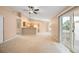 Open concept living area with neutral carpet flowing into the kitchen and adjacent dining space at 11640 W 62Nd Pl # 203, Arvada, CO 80004