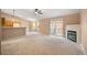 Bright living room featuring plush carpet, a fireplace, and sliding glass doors to the outside at 11640 W 62Nd Pl # 203, Arvada, CO 80004