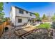 Well-maintained backyard with a lush lawn, a patio, a grill, and manicured landscaping at 1300 W 13Th Ave, Broomfield, CO 80020