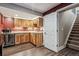 Basement bar area features light wood cabinets, granite counters, mini fridge, and hardwood style floors at 1300 W 13Th Ave, Broomfield, CO 80020