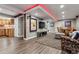 Spacious finished basement featuring a kitchenette, living area, dining table, and wood-look floors at 1300 W 13Th Ave, Broomfield, CO 80020