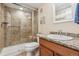 Bathroom featuring a glass-enclosed shower, granite countertop, updated fixtures, and modern toilet at 1300 W 13Th Ave, Broomfield, CO 80020