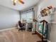 Versatile room featuring a sewing machine, crafting supplies, carpet flooring and a ceiling fan at 1300 W 13Th Ave, Broomfield, CO 80020