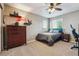Tranquil bedroom with a dresser, bedside table, carpeted floor, and plenty of natural light at 1300 W 13Th Ave, Broomfield, CO 80020