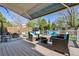 Inviting outdoor deck with plush seating, a patio umbrella, string lights, and views of the backyard at 1300 W 13Th Ave, Broomfield, CO 80020