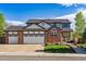 Attractive two-story home with a brick facade, a three-car garage, and manicured landscaping at 1300 W 13Th Ave, Broomfield, CO 80020