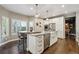 Gourmet kitchen features island with seating, stainless appliances, and hardwood floors at 1300 W 13Th Ave, Broomfield, CO 80020