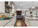Modern kitchen with stainless steel appliances, white cabinetry, and an open layout to the living room at 1300 W 13Th Ave, Broomfield, CO 80020