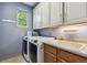 Functional laundry room with washer, dryer, sink, and ample storage at 1300 W 13Th Ave, Broomfield, CO 80020