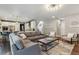 Spacious living room open to kitchen featuring hardwood floors, fireplace, and comfortable gray seating at 1300 W 13Th Ave, Broomfield, CO 80020
