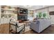 Stylish living room with a fireplace, built-in shelving, hardwood floors and comfortable seating at 1300 W 13Th Ave, Broomfield, CO 80020