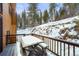 Snow covered deck with picnic table at 65 Cottonwood Dr, Evergreen, CO 80439