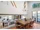 Bright dining room with a rustic table and view of the living area at 65 Cottonwood Dr, Evergreen, CO 80439