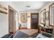 Bright entryway with coat rack, sitting area, and tiled floor at 65 Cottonwood Dr, Evergreen, CO 80439