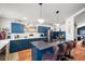 Updated kitchen featuring blue cabinets, an island, and hardwood floors at 65 Cottonwood Dr, Evergreen, CO 80439