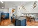 Modern kitchen with blue cabinetry, island, and view to dining area at 65 Cottonwood Dr, Evergreen, CO 80439