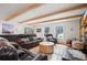 Spacious living room with exposed beams, fireplace, and leather sofas at 65 Cottonwood Dr, Evergreen, CO 80439