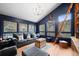 Modern living room with dark walls, large windows, and a ladder at 65 Cottonwood Dr, Evergreen, CO 80439