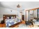 Main bedroom with wood floors and built-in shelving at 65 Cottonwood Dr, Evergreen, CO 80439