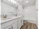 Bathroom with double vanity, tub, and neutral tile at 674 Penn Rd, Elizabeth, CO 80107