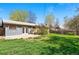 Backyard featuring a grassy lawn, concrete patio, and partially fenced in yard at 7065 Ingalls Ct, Arvada, CO 80003