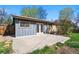 Exterior view of backyard, featuring a concrete patio, wood fence, and mature trees at 7065 Ingalls Ct, Arvada, CO 80003